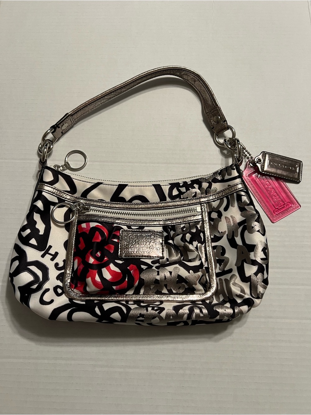 Coach Poppy small satin shoulder bag with pink accents and lining